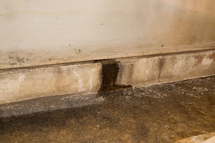 water leaking from a building foundation